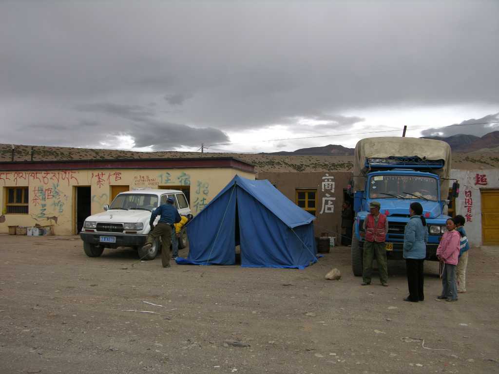 Tibet Guge 01 To 02 Sangsha Outside On the way from Kailash to Tholing and the Guge Kingdom, we stopped for the night at the army base at Sangsha (4560m). Our kitchen tent was held up by the truck and Landcruiser.